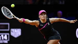 Photo: Marijan Murat/dpa via AP : Poland's Iga Swiatek plays Britain's Emma Raducanu during her quarter-finals tennis match at the WTA Tour in Stuttgart.