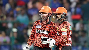 AP Photo/Kashif Masood : Sunrisers Hyderabad's Travis Head, left, and Abhishek Sharma chat during the Indian Premier League cricket match between Royal Challengers Bengaluru and Sunrisers Hyderabad in Bengaluru.