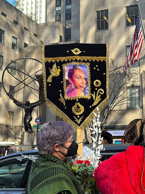 People with flowers and a banner honoring Cecilia Gentili outside St. Patrick's Cathedral in Manhattan on Feb. 15, 2024, in New York.