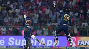 AP Photo/Surjeet Yadav : Gujarat Titans' Rashid Khan, left, and teammate Noor Ahmad celebrate their team's victory during the Indian Premier League cricket match against Rajasthan Royals in Jaipur.