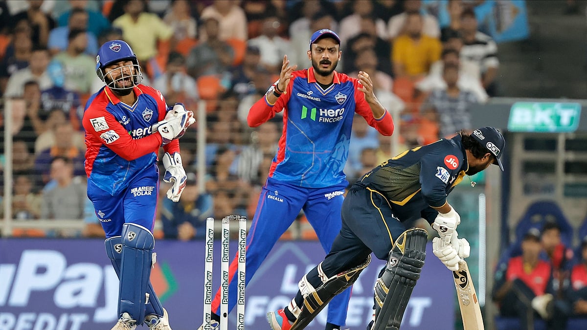 AP Photo/Pravin Indrekar : Delhi Capitals' captain Rishabh Pant, left, appeals unsuccessfully for the stumping of Gujarat Titans' Rahul Tewatia during the Indian Premier League cricket match between Delhi Capitals and Gujarat Titans in Ahmedabad.