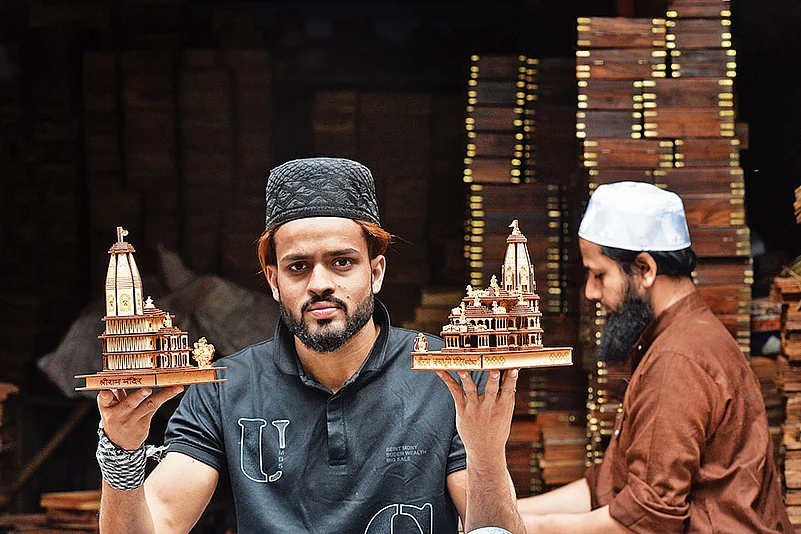 No Boundaries: Wood carver Mohd Muzammil holds up a replica of Ram temple at the Khata Khedi market in Saharanpur 