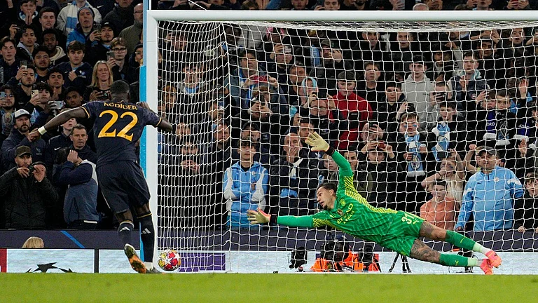 Manchester City's goalkeeper Ederson, right, fails to save as Real Madrid's Antonio Rudiger scores the winning penalty in the UEFA Champions League quarter-final, second leg match at the Etihad Stadium in Manchester on Thursday (April 18, 2024). - AP/Dave Shopland