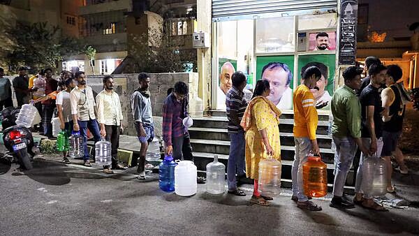 PTI : People standing in queue with water cans in Bengaluru |