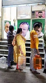 People standing in queque with water containers in Bengaluru |
