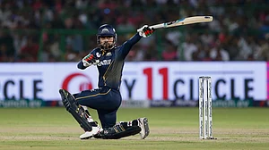 AP Photo/Surjeet Yadav : Gujarat Titans' Rashid Khan bats during the Indian Premier League cricket match between Gujarat Titans and Rajasthan Royals in Jaipur.