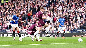 Andrew Milligan/PA : Rangers’ Cyriel Dessers (left) scores against Hearts.