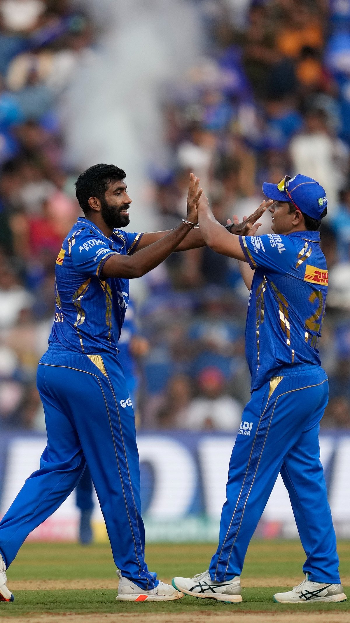 AP Photo : Jasprit Bumrah celebrates the wicket of DC batter with Piyush Chawla.