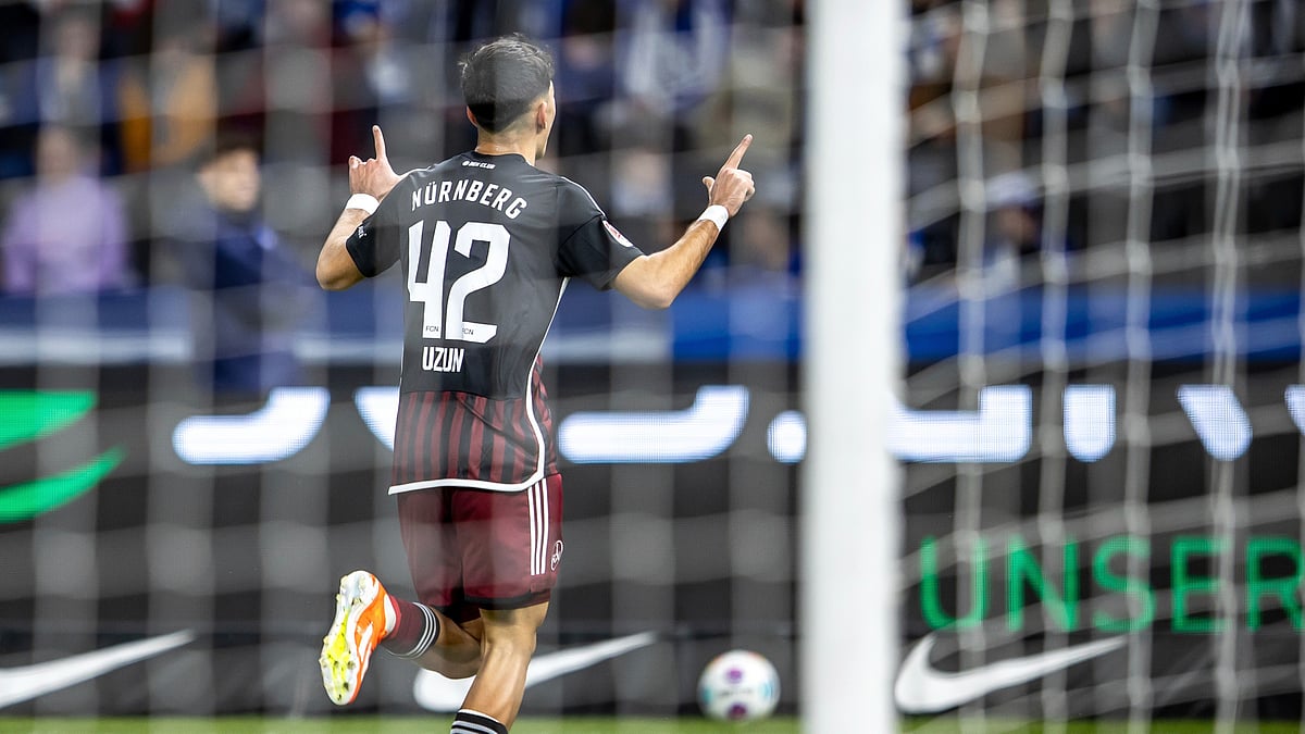 Photo: Andreas Gora/dpa via AP : Nuremberg's Can Uzun, celebrates scoring a goal, during the Bundesliga second division match between Hertha Berlin and Nuremberg, in Berlin.