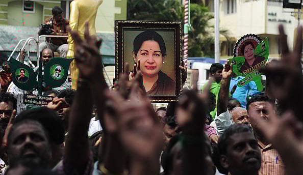 (Photo via Getty Images) : Members of the All India Anna Dravida Munnetra Kazhagam(AIADMK) party carry placards with the image of AIADMK leader Jayalalithaa Jayaram as they celebrate in front of her residence in Chennai on May 19, 2016. 