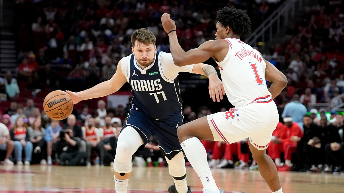 AP Photo/Eric Christian Smith : Dallas Mavericks guard Luka Doncic (77) drives against Houston Rockets forward Amen Thompson during the first half of an NBA basketball game in Houston.