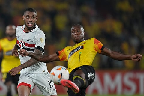 Andre Silva of Brazil's Sao Paulo, left, and Anibal Chala of Ecuador's Barcelona SC battle for the ball during a Copa Libertadores Group B match at Monumental Banco Pichincha stadium in Guayaquil, Ecuador.