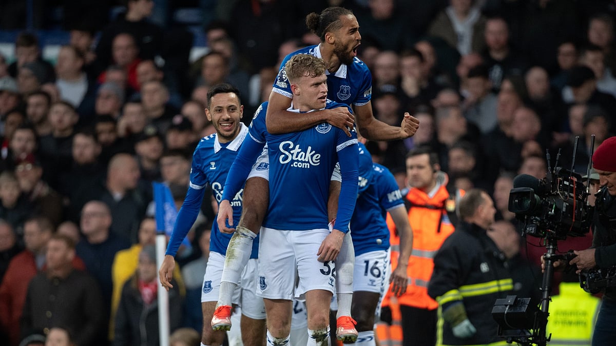 Everton players celebrate a goal against Liverpool.