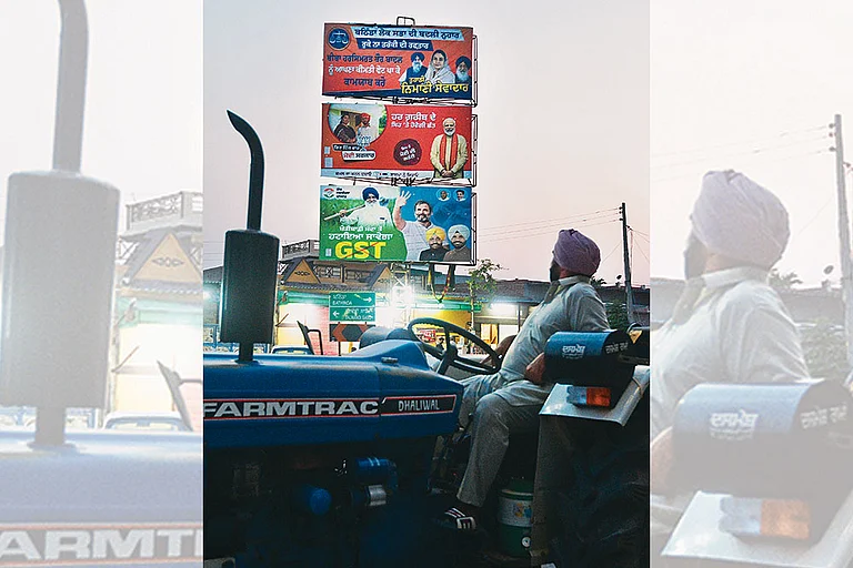 Too Many Options:  A farmer in 
Jalandhar looks at the hoardings 
of different political parties - Photo: Tribhuvan Tiwari