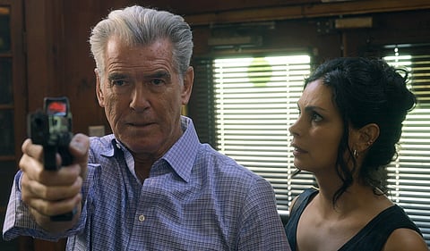 Pierce Brosnan And Morena Baccarin In A Still From ‘Fast Charlie’