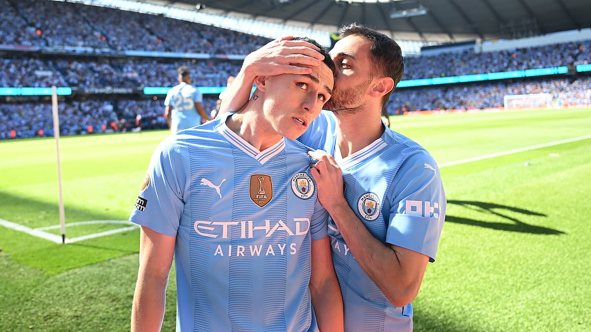 Phil Foden celebrates with Bernardo Silva (right) after opening the scoring for Manchester City on Sunday - null
