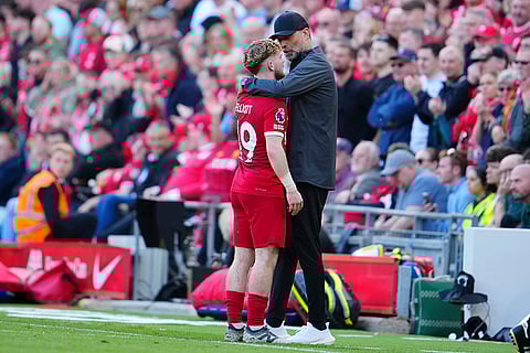 Liverpool's Jurgen Klopp hugs Harvey Elliott