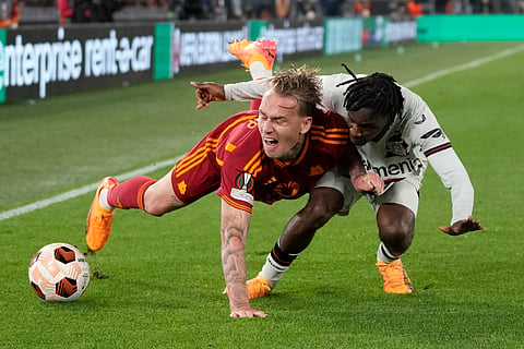 Roma's Rick Karsdorp, left, and Leverkusen's Jeremie Frimpong