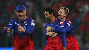 AP Photo/Kashif Masood : Royal Challengers Bengaluru's Swapnil Singh, centre, celebrates the dismissal of Delhi Capitals' David Warner during the Indian Premier League cricket match between Royal Challengers Bengaluru and Delhi Capitals in Bengaluru.