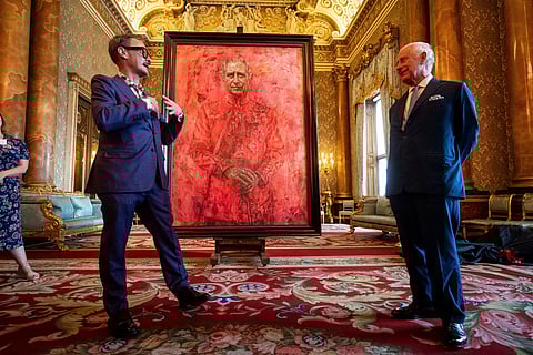 Artist Jonathan Yeo, left, and Britain's King Charles III at the unveiling of artist Yeo's portrait of the King, in the blue drawing room at Buckingham Palace, in London, Tuesday May 14, 2024.
