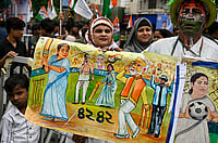 In West Bengal, Graffiti Walls Tell Us Key Issues Dominating This Election Samir Jana/Hindustan Times via Getty Images : An All India Trinamool Congress (AITC) supporter holds a poster during a rally before nomination file for General Election 2024 at Hazra on May 10, 2024 in Kolkata, India