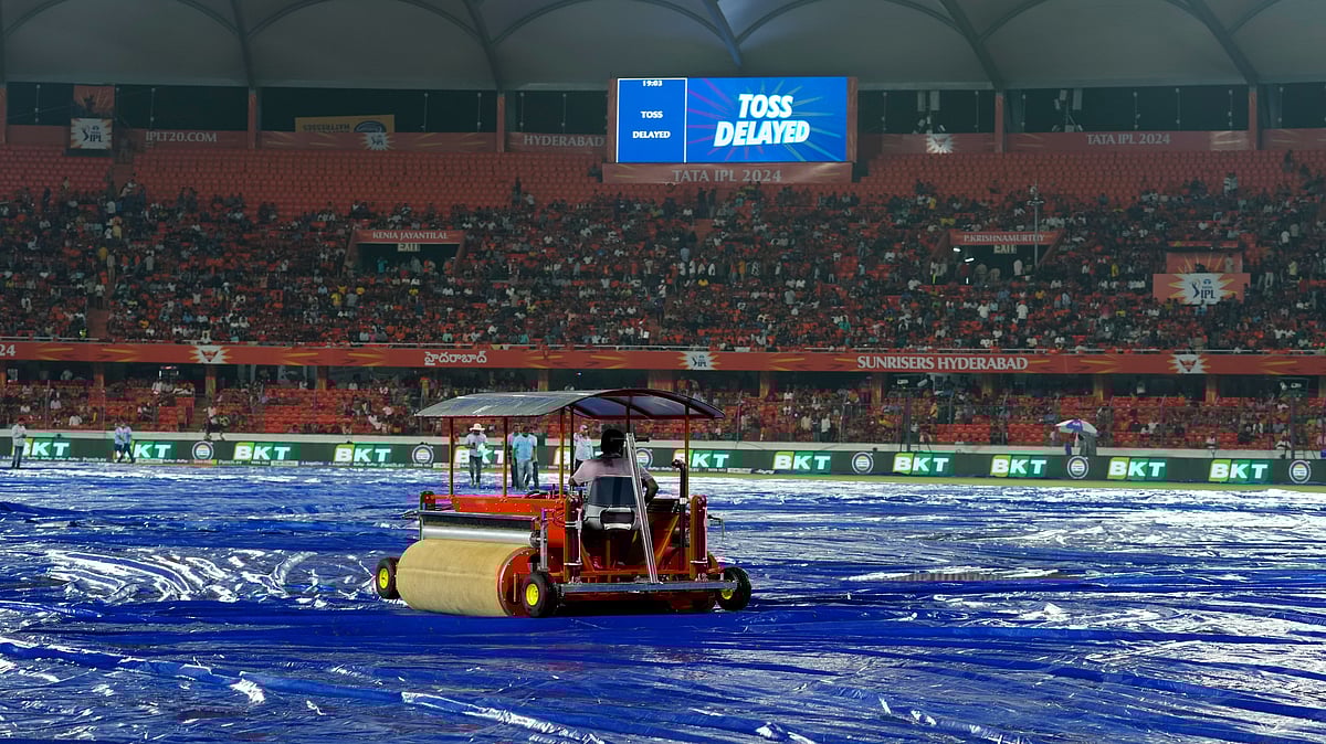 A water-soaking vehicle removes water from the rain covers as the Indian Premier League cricket match between Gujrat Titans and Sunrisers Hyderabad is delayed due to rain in Hyderabad. - AP Photo /Mahesh Kumar A.