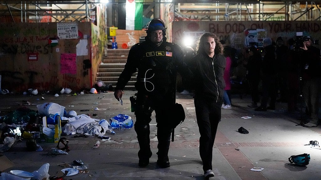 AP : A demonstrator is detained and escorted out of an encampment on the UCLA campus Thursday, May 2, 2024, in Los Angeles. 