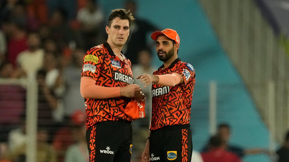 Sunrisers Hyderabad's Bhuvneshwar Kumar, right, interacts with captain Pat Cummins during the Indian Premier League qualifier cricket match between Kolkata Knight Riders and Sunrisers Hyderabad in Ahmedabad. - AP Photo/Ajit Solanki