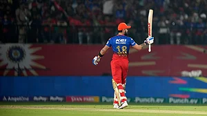 AP Photo /Ashwini Bhatia : Royal Challengers Bengaluru's Virat Kohl celebrates his fifty runs during the Indian Premier League cricket match between Punjab Kings and Royal Challengers Bengaluru in Dharamsala.