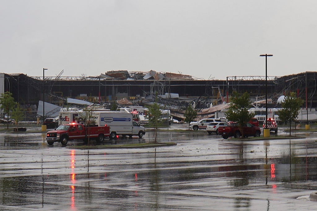 Emergency vehicles respond after a tornado damaged a FedEx facility in Portage, Mich. - AP
