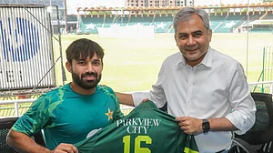 Photo: X/ @TheRealPCB : Mohammad Rizwan was given a shirt by PCB chief Mohsin Naqvi for completing 3000 runs in T20.