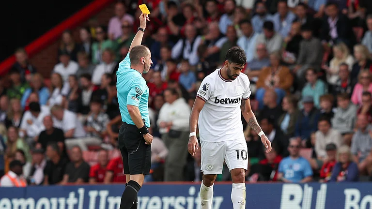 Lucas Paqueta is shown a yellow card during West Ham's 1-1 draw at Bournemouth last August. - null