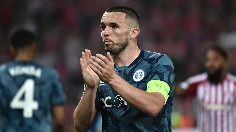 John McGinn applauds Aston Villa's travelling fans after Thursday's game - null