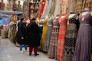 Getty Images : Two women customers browse garments in a retail business
