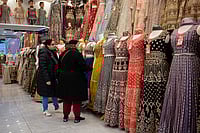 Getty Images : Two women customers browse garments in a retail business