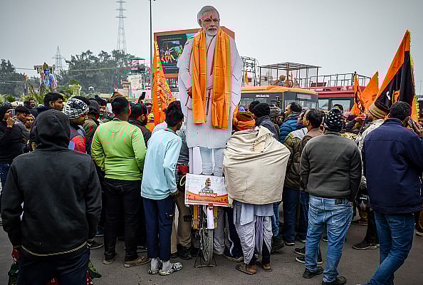 Devotees gather near the effigy of Indian Prime minister Narendra Modi ahead of the Inauguration of the Ram Mandir Temple on January 20, 2024 in Ayodhya, India. The Ram Mandir, built at a site thought to be the birth place of Lord Rama, a significant figure in Hindu religion, will be inaugurated on January 22nd. - Getty Images