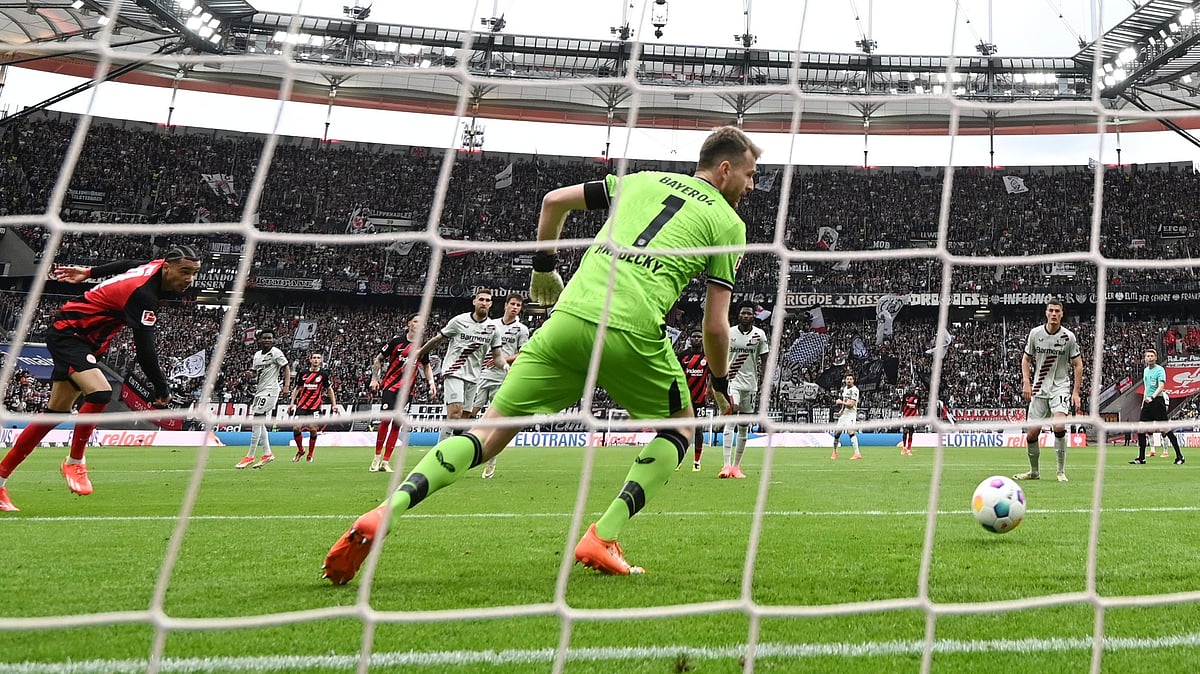 AP : Eintracht Frankfurt's Hugo Ekitik', left, scores the goal to make it 1-1 against Leverkusen goalkeeper Lukas Hradecky during a Bundesliga soccer match.