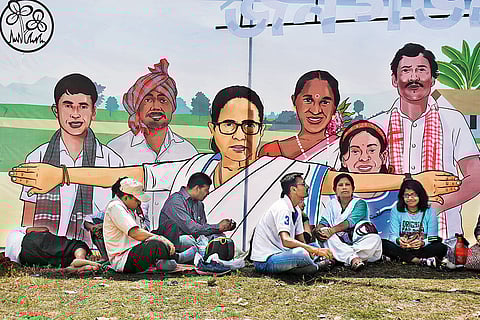 A United Force: Trinamool Congress members taking a break in the shade of a banner featuring party chief Mamata Banerjee during a Lok Sabha election campaign in Kolkata