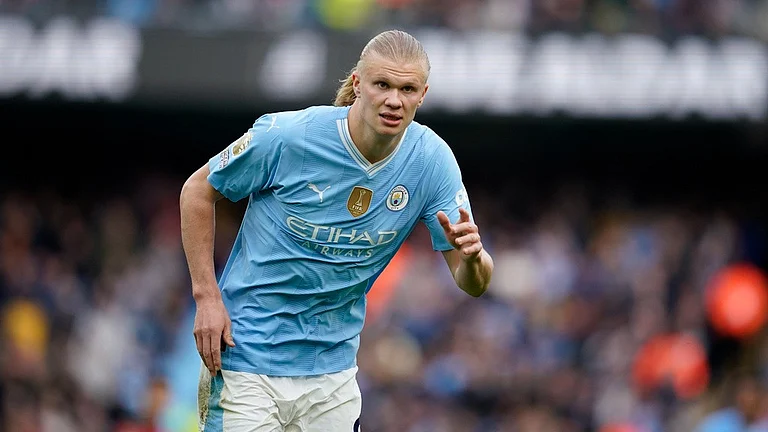 Erling Haaland stole the show with four goals as Manchester City kept hot on the tail of Arsenal. - AP/Dave Thompson