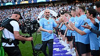 File Photo : Pep Guardiola walks down to celebrate with Manchester City players en route to lifting the 2023/24 Premier League trophy.