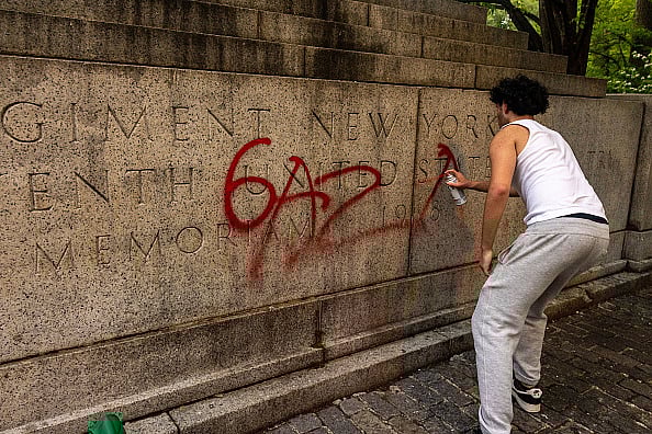  Alex Kent/Getty Images :  A pro-Palestine protestor writes Gaza on a memoriam near Central Park during a march on the outskirts of the Met Gala on May 6, 2024 in New York City. A demonstration at Hunter College drew around 200 protesters, who joined other area-college marches to the Met Gala being held this evening at the Metropolitan Museum of Art.