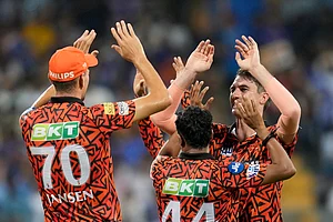 Rajanish Kakade/AP : Sunrisers Hyderabad's captain Pat Cummins, right, celebrates the wicket of Mumbai Indians' Rohit Sharma with teammates during their Indian Premier League 2024 match in Mumbai on May 6, 2024.
