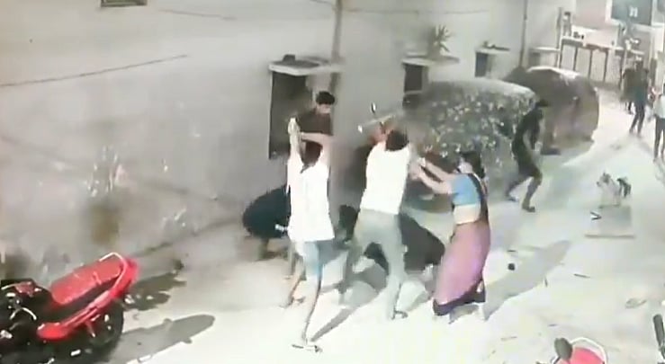 X : CCTV footage of the incident shows a group of men blowing repeated attacks on a man and his dog with sticks. 