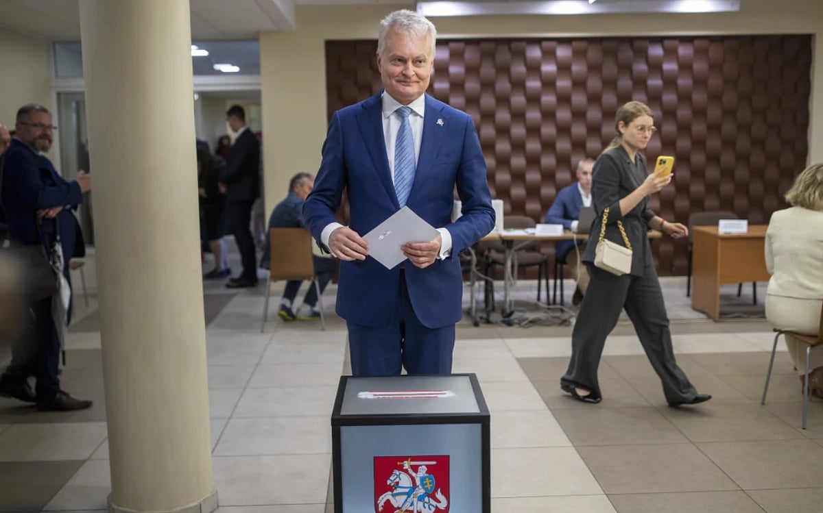 AP : Lithuania’s President Gitanas Nauseda, a presidential candidate, prepares to cast his ballot at a polling station during the advance presidential elections in the small town of Svencionys, some 85km (52,8 miles) north of the capital Vilnius, Lithuania, Thursday, May 23, 2024. The second round of presidential vote in Lithuania will take place on May 26. Lithuania’s incumbent president won the most votes in the first round with 44% of the votes but he still faces a runoff against the country’s prime minister. 