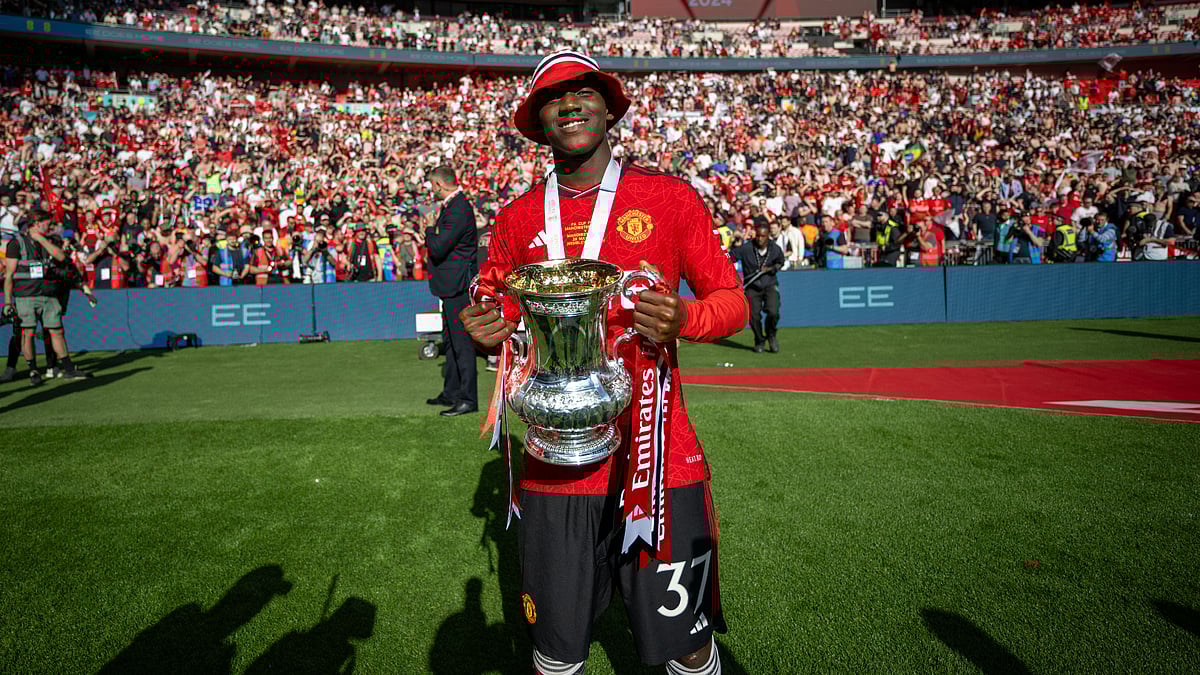Kobbie Mainoo celebrates with the FA Cup trophy, as the England midfielder hopes to make the Euro 2024 squad next month.