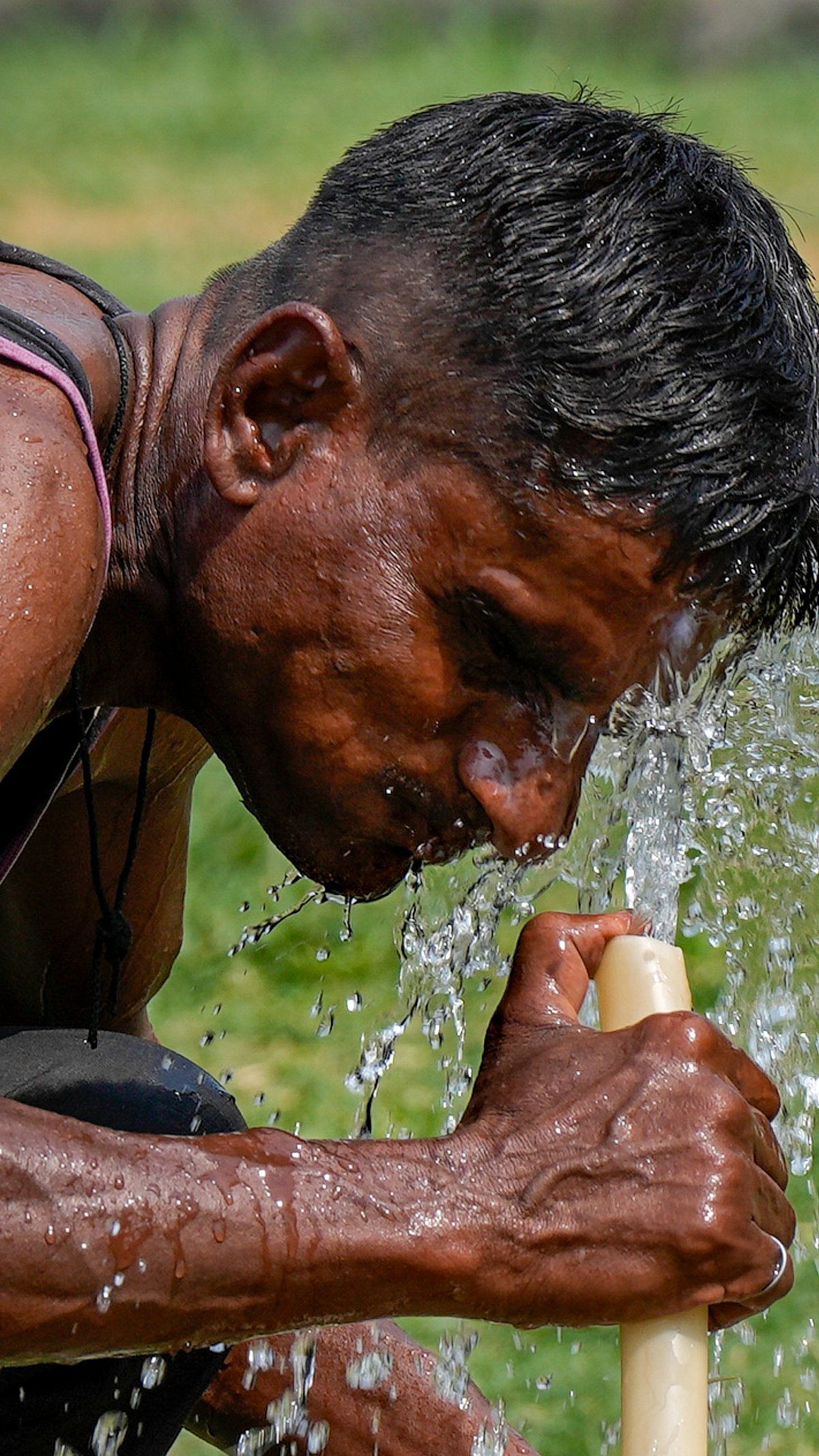 PTI : Man splashes water on his face in this intense heatwave. 