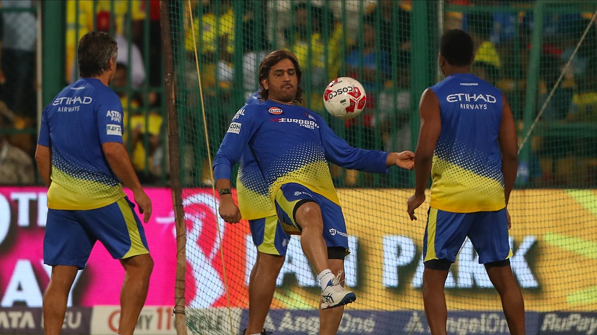AP Photo/Kashif Masood : Chennai Super Kings MS Dhoni, centre, warms up before the start of the Indian Premier League cricket match between Royal Challengers Bengaluru and Chennai Super Kings in Bengaluru.