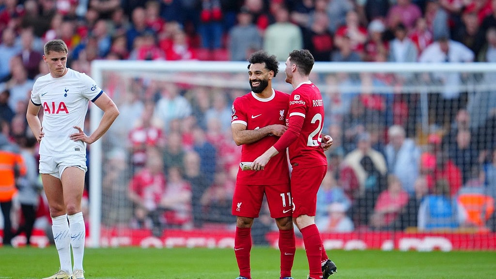 Photo: AP/Jon Super : Andrew Robertson, right, and Mohamed Salah, center, celebrate Liverpool's victory over Tottenham Hotspur in the English Premier League at Anfield Stadium on Sunday, May 5, 2024.