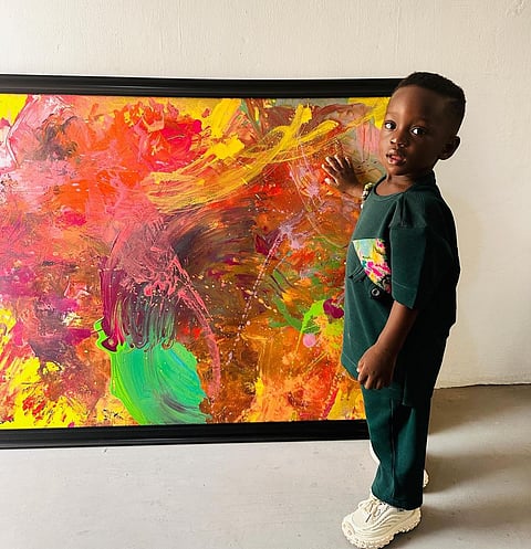Ace Liam with one of his paintings.