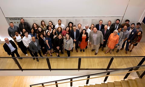 Staff members of The Washington Post who were part of the team awarded the Pulitzer Prize for National Reporting for an examination of the AR-15, stand for a photo in front of the newsroom's Pulitzer wall, Monday, May 6, 2024, in Washington.
